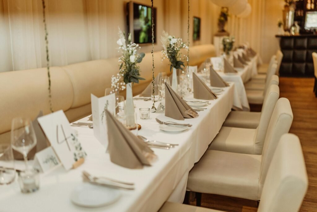 Beautifully decorated restaurant tables with floral arrangements, ready for a celebration.