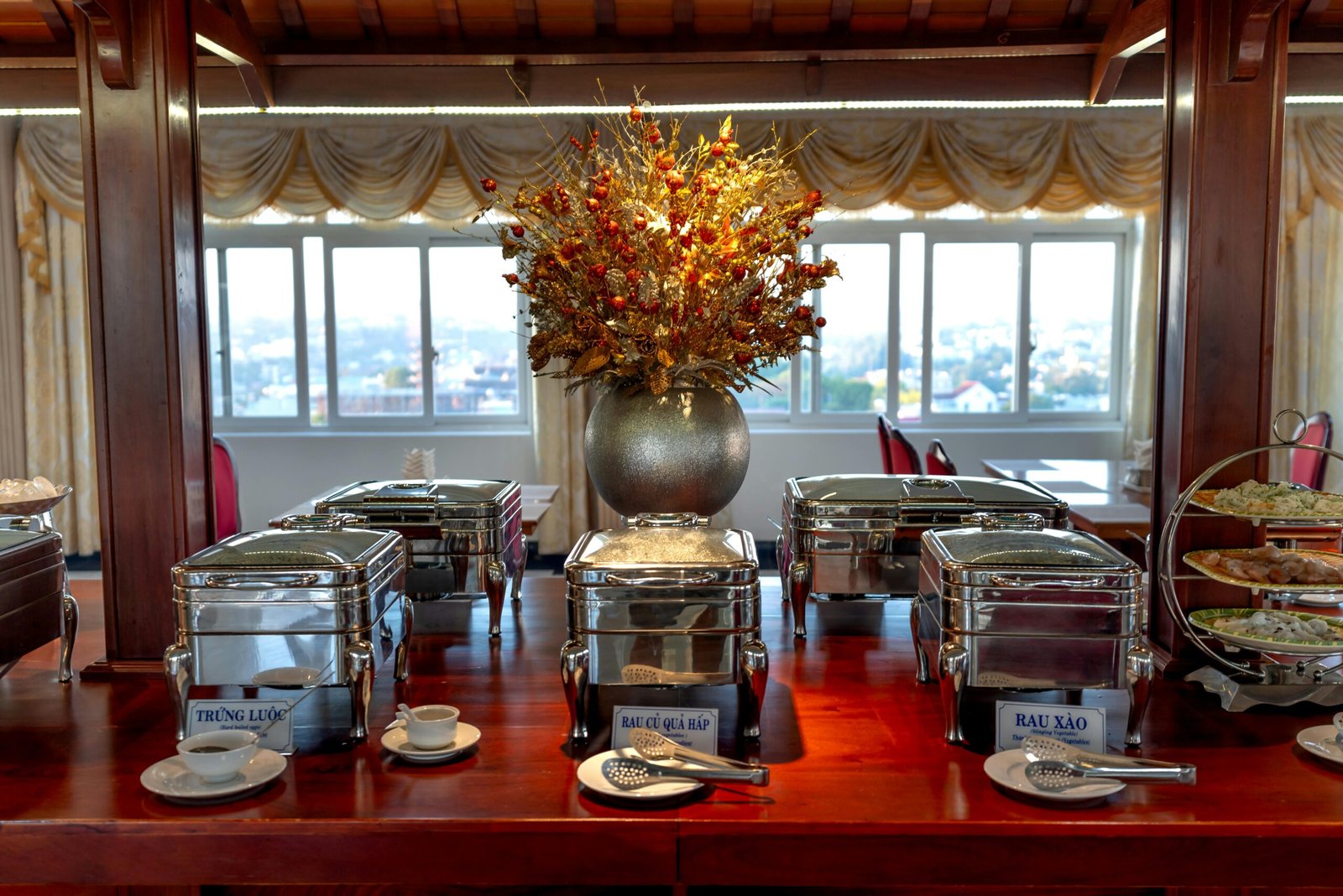 Luxurious buffet setup in an elegant dining room with decorative elements and ambient lighting.